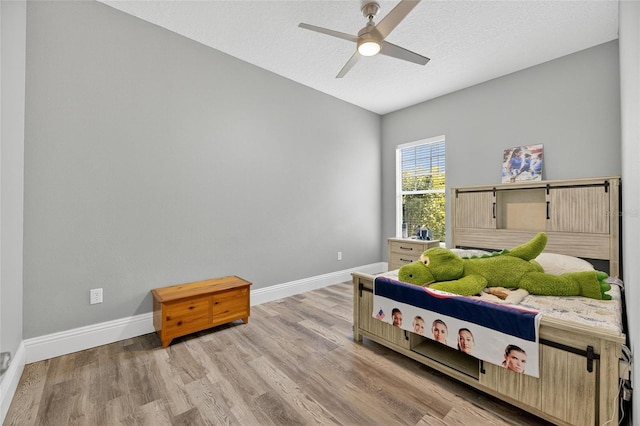 5720 Tortoise Pl, Apollo Beach, FL 33572 - bedroom featuring light wood finished floors, ceiling fan, a textured ceiling, and lofted ceiling