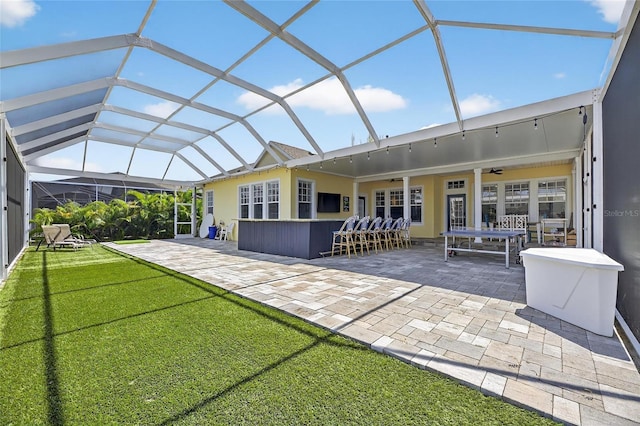 5720 Tortoise Pl, Apollo Beach, FL 33572 - back of house featuring a patio, a ceiling fan, a lawn, and glass enclosure