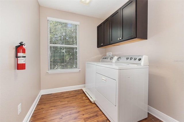 1395 Alston Bay Blvd, Apopka, FL 32703 - laundry area with washing machine and dryer, cabinet space, and light wood-style flooring