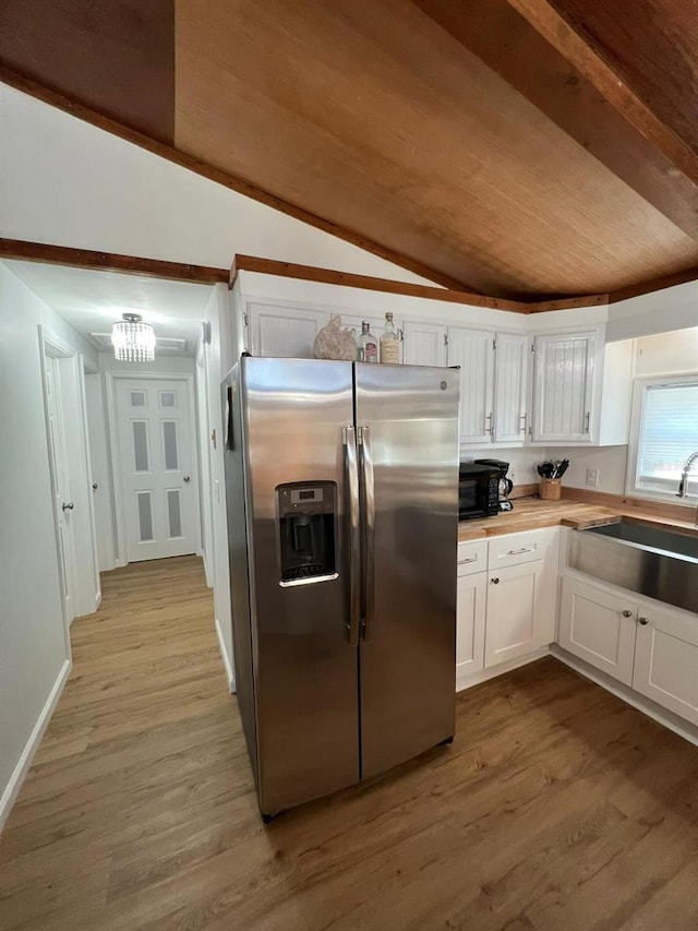 123 Rocky Rd, Lackawaxen, PA 18435 - kitchen featuring stainless steel refrigerator with ice dispenser, lofted ceiling, white cabinetry, light wood-style floors, and a chandelier