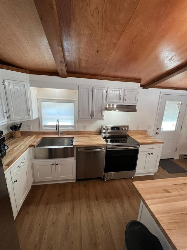 123 Rocky Rd, Lackawaxen, PA 18435 - kitchen with butcher block countertops, appliances with stainless steel finishes, under cabinet range hood, a wooden ceiling with exposed beams, and dark wood-type flooring