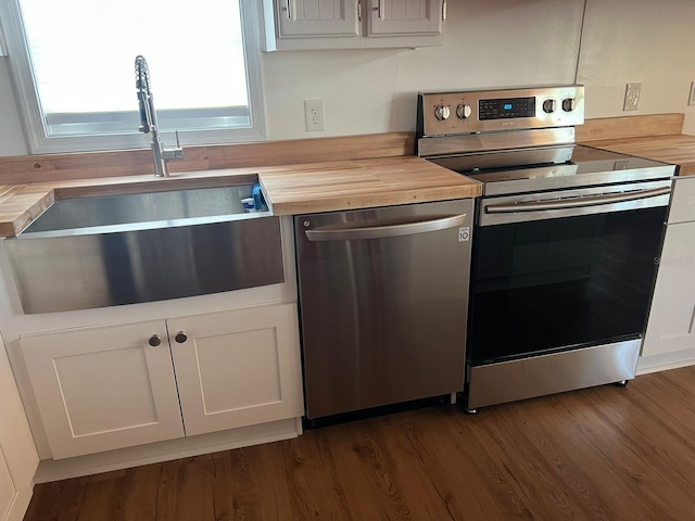 123 Rocky Rd, Lackawaxen, PA 18435 - kitchen with appliances with stainless steel finishes, white cabinets, and dark wood-style floors