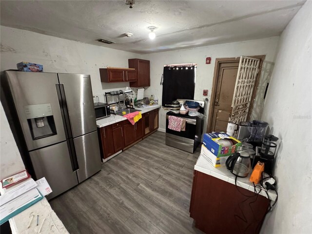 6951 NW 5th Ct, Miami, FL 33150 - kitchen featuring appliances with stainless steel finishes, light countertops, and dark wood-style floors