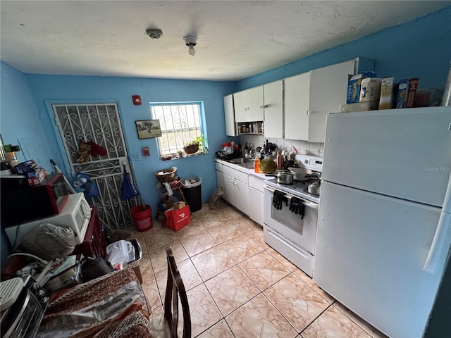 6951 NW 5th Ct, Miami, FL 33150 - kitchen featuring white appliances and white cabinetry