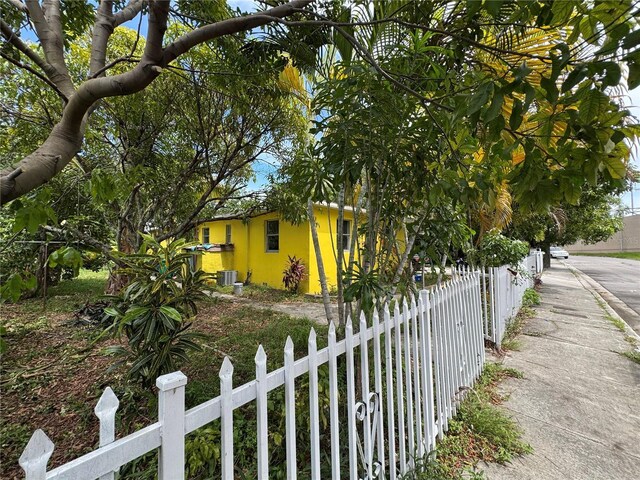 6951 NW 5th Ct, Miami, FL 33150 - view of side of home with a fenced front yard and stucco siding
