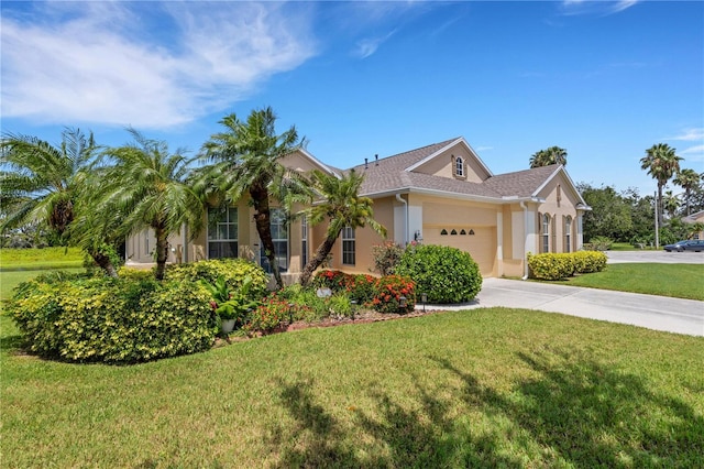 3503 92nd Ave E, Parrish, FL 34219 - view of front of home with a garage, a front yard, stucco siding, and concrete driveway