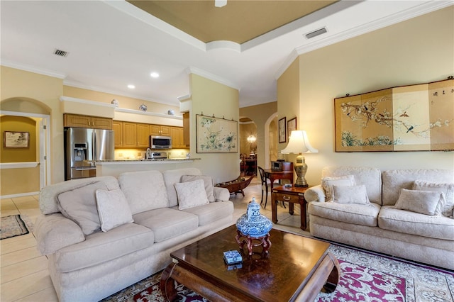 3503 92nd Ave E, Parrish, FL 34219 - living room with arched walkways, ornamental molding, light tile patterned floors, and recessed lighting