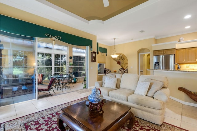 3503 92nd Ave E, Parrish, FL 34219 - tiled living room featuring ornamental molding, arched walkways, a ceiling fan, and recessed lighting