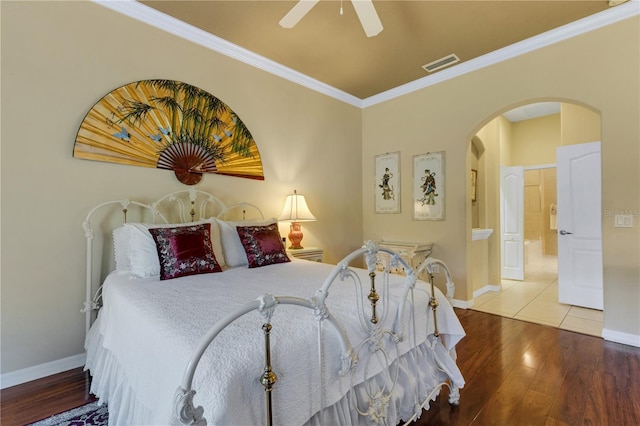 3503 92nd Ave E, Parrish, FL 34219 - bedroom featuring arched walkways, crown molding, wood finished floors, and a ceiling fan