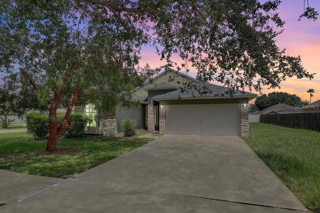 1462 Lake Shore Ranch Dr, Seffner, FL 33584 - view of front facade featuring stone siding, concrete driveway, and a garage