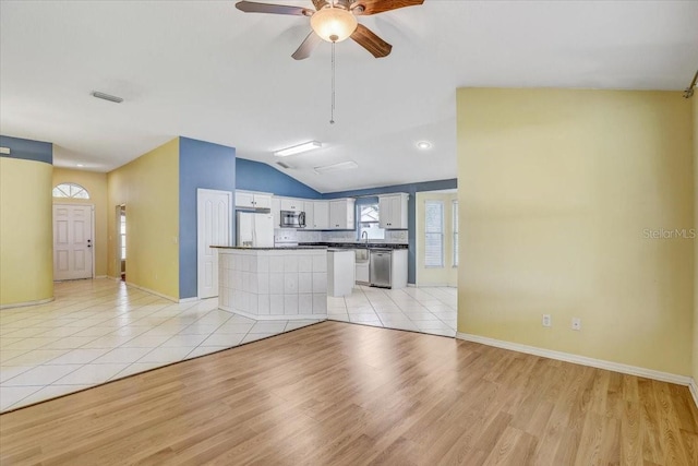 1462 Lake Shore Ranch Dr, Seffner, FL 33584 - unfurnished living room featuring light wood-style flooring, vaulted ceiling, and a ceiling fan