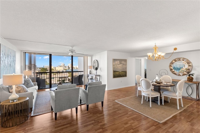 400 Island Way Unit 503, Clearwater Beach, FL 33767 - living room featuring a textured ceiling, wood finished floors, a chandelier, expansive windows, and a ceiling fan