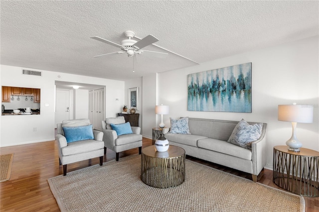 400 Island Way Unit 503, Clearwater Beach, FL 33767 - living room with light wood-type flooring, a ceiling fan, and a textured ceiling