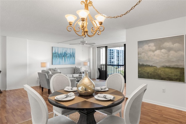 400 Island Way Unit 503, Clearwater Beach, FL 33767 - dining room featuring a chandelier, light wood-type flooring, ceiling fan, and a textured ceiling
