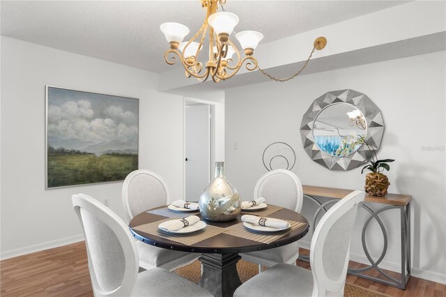 400 Island Way Unit 503, Clearwater Beach, FL 33767 - dining room featuring a chandelier and wood finished floors