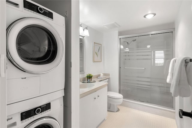 400 Island Way Unit 503, Clearwater Beach, FL 33767 - laundry area featuring stacked washer / dryer and tile patterned flooring