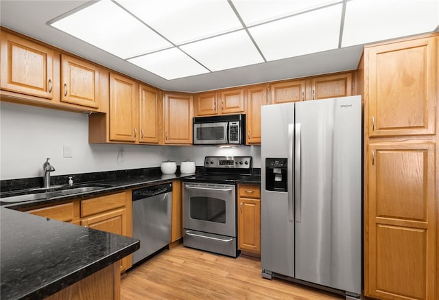 400 Island Way Unit 503, Clearwater Beach, FL 33767 - kitchen featuring appliances with stainless steel finishes, light wood-type flooring, and dark stone counters