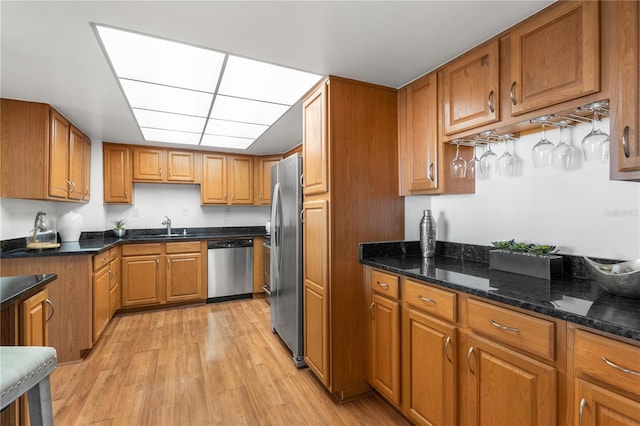 400 Island Way Unit 503, Clearwater Beach, FL 33767 - kitchen with stainless steel appliances, brown cabinetry, and light wood finished floors
