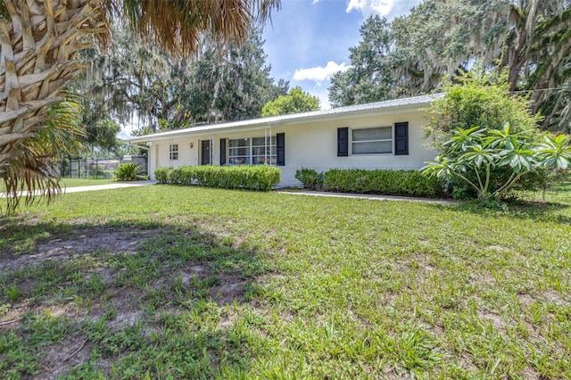 6607 S Merleing Loop, Floral City, FL 34436 - ranch-style house with a front lawn, stucco siding, and a metal roof