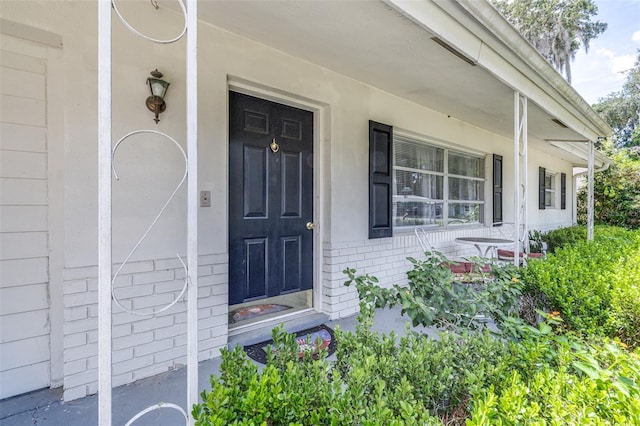 6607 S Merleing Loop, Floral City, FL 34436 - entrance to property with a porch and brick siding