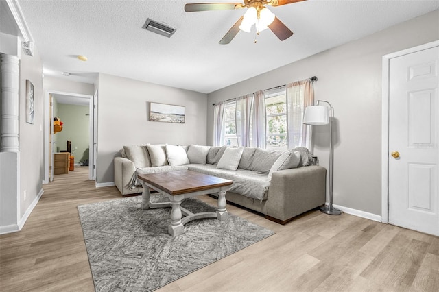 6607 S Merleing Loop, Floral City, FL 34436 - living area with light wood-style floors, ceiling fan, and a textured ceiling