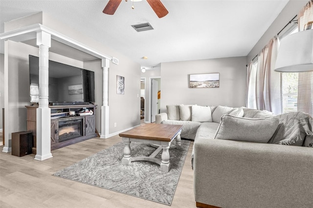 6607 S Merleing Loop, Floral City, FL 34436 - living room featuring a ceiling fan, light wood-type flooring, and a glass covered fireplace