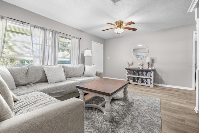 6607 S Merleing Loop, Floral City, FL 34436 - living area with wood finished floors, ceiling fan, and a textured ceiling