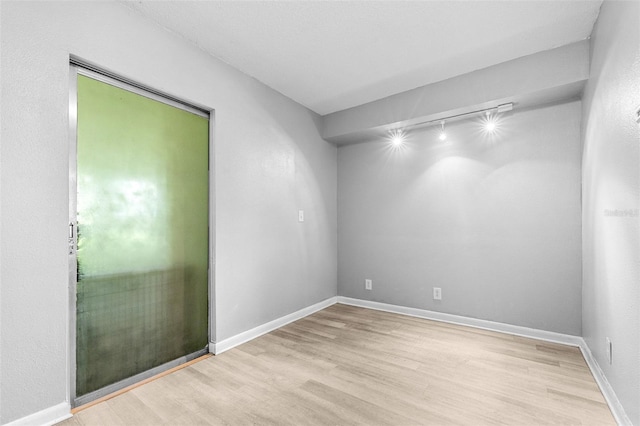 6607 S Merleing Loop, Floral City, FL 34436 - empty room with wood finished floors and rail lighting
