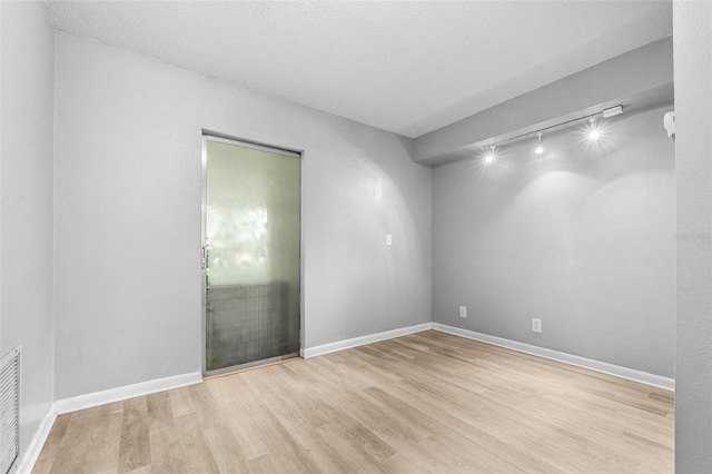 6607 S Merleing Loop, Floral City, FL 34436 - unfurnished room featuring wood finished floors and track lighting