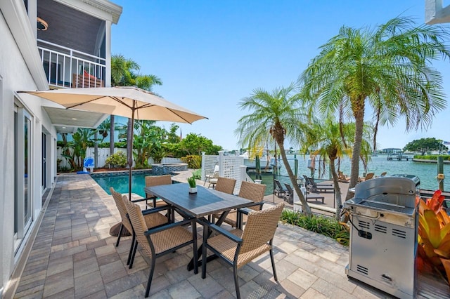 4545 Harbor Hills Dr, Largo, FL 33770 - view of patio / terrace featuring grilling area, outdoor dining space, a water view, an outdoor pool, and a sunroom