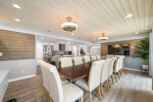 4545 Harbor Hills Dr, Largo, FL 33770 - dining space featuring wooden ceiling, wood walls, light wood-type flooring, recessed lighting, and a wainscoted wall