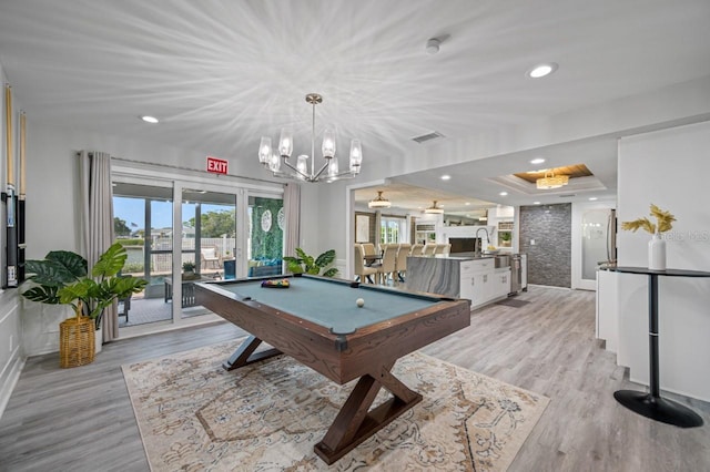 4545 Harbor Hills Dr, Largo, FL 33770 - rec room featuring billiards table, light wood-type flooring, a chandelier, and a raised ceiling