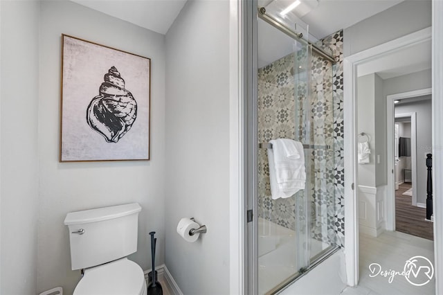4545 Harbor Hills Dr, Largo, FL 33770 - bathroom featuring toilet and shower / bath combination with glass door