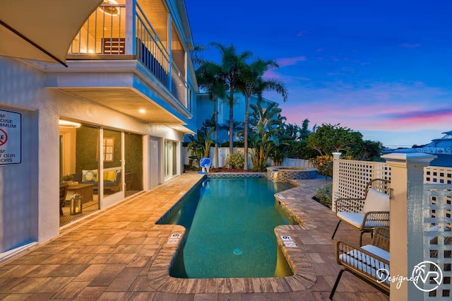 4545 Harbor Hills Dr, Largo, FL 33770 - pool at dusk featuring a patio area and a pool with connected hot tub