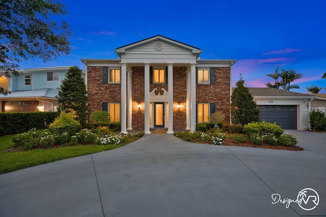 4545 Harbor Hills Dr, Largo, FL 33770 - neoclassical home featuring brick siding, concrete driveway, and a garage
