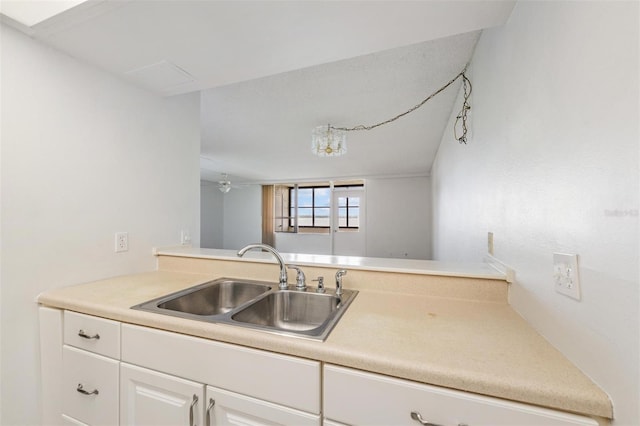 2617 Cove Cay Dr Unit 706, Clearwater, FL 33760 - kitchen with white cabinets, light countertops, and a ceiling fan