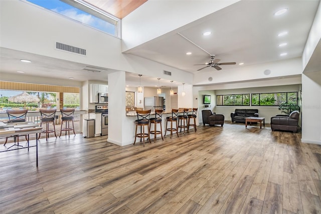 2617 Cove Cay Dr Unit 706, Clearwater, FL 33760 - living room with wood finished floors, a ceiling fan, and recessed lighting