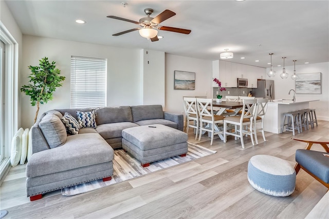15305 1st St E Unit 305, Madeira Beach, FL 33708 - living area with light wood finished floors, ceiling fan, and recessed lighting
