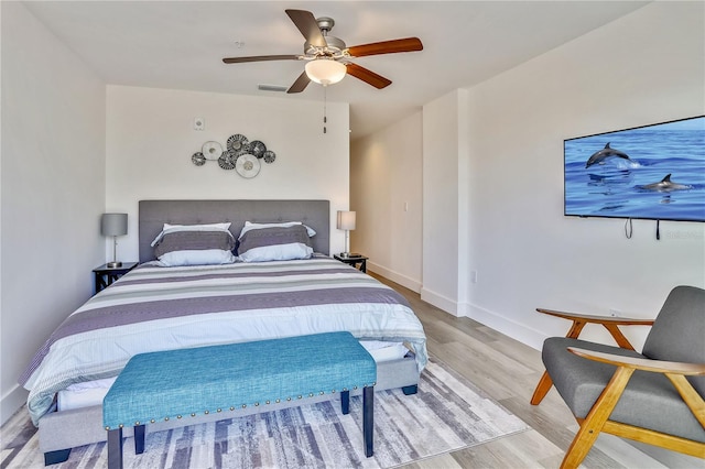 15305 1st St E Unit 305, Madeira Beach, FL 33708 - bedroom featuring wood finished floors and ceiling fan