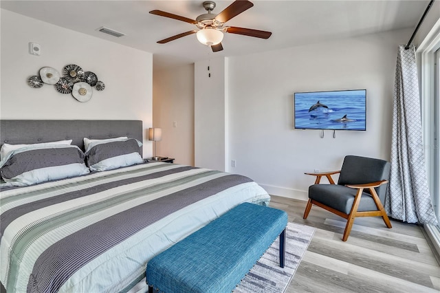 15305 1st St E Unit 305, Madeira Beach, FL 33708 - bedroom with light wood finished floors and ceiling fan