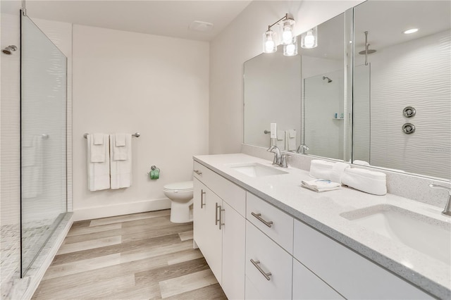 15305 1st St E Unit 305, Madeira Beach, FL 33708 - full bath with double vanity, walk in shower, and wood finished floors
