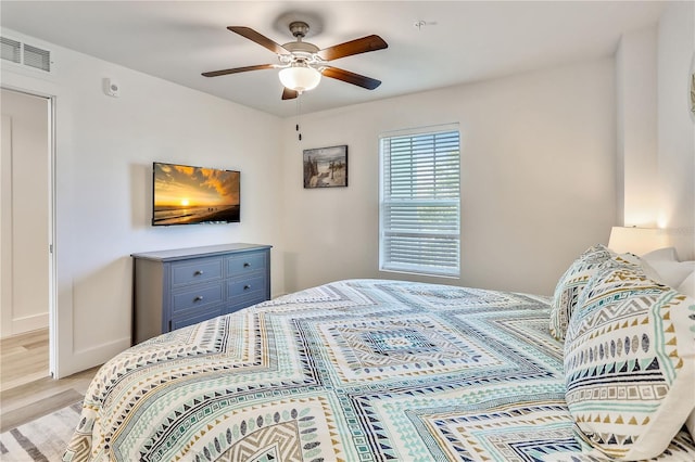 15305 1st St E Unit 305, Madeira Beach, FL 33708 - bedroom with light wood-style floors and a ceiling fan