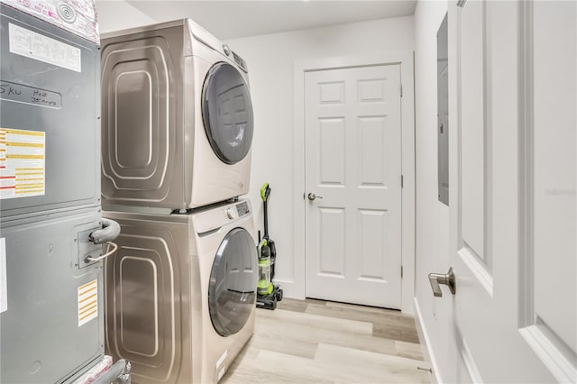 15305 1st St E Unit 305, Madeira Beach, FL 33708 - laundry room with stacked washer / drying machine and wood finished floors