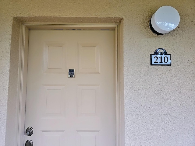 3076 Eastland Blvd Unit 210, Clearwater, FL 33761 - view of exterior entry featuring stucco siding