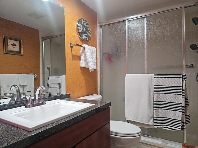 3076 Eastland Blvd Unit 210, Clearwater, FL 33761 - bathroom with vanity, a textured wall, and a shower with door