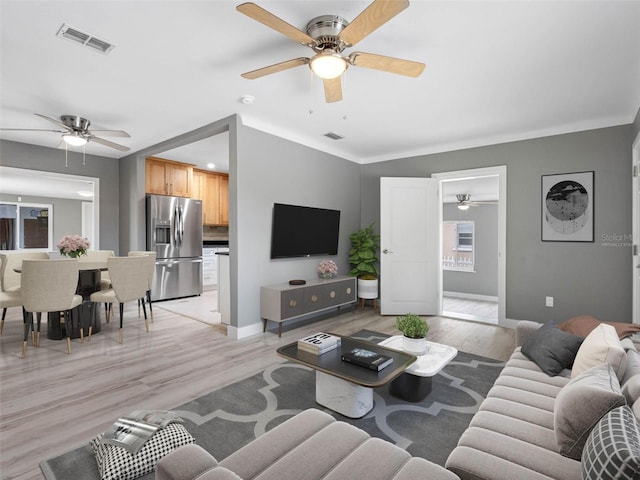 540 80th Ave, St Pete Beach, FL 33706 - living area featuring ceiling fan and light wood-type flooring