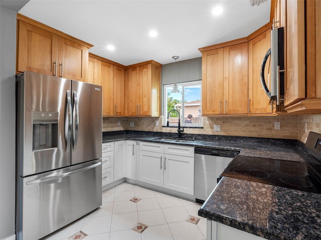540 80th Ave, St Pete Beach, FL 33706 - kitchen with appliances with stainless steel finishes, tasteful backsplash, light tile patterned floors, recessed lighting, and dark stone counters