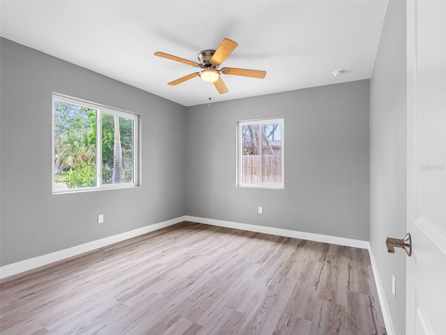 540 80th Ave, St Pete Beach, FL 33706 - empty room featuring healthy amount of natural light, wood finished floors, and ceiling fan