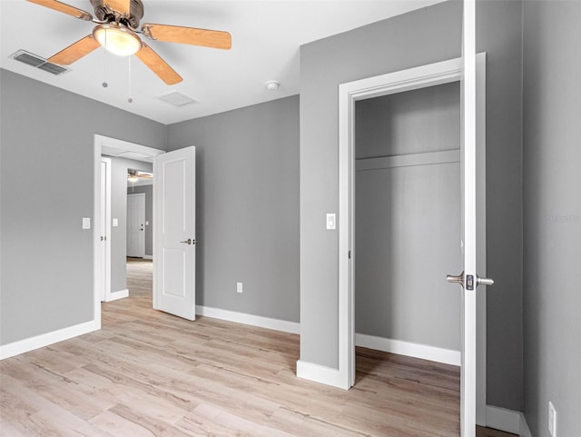 540 80th Ave, St Pete Beach, FL 33706 - unfurnished bedroom with light wood-style flooring, a closet, and a ceiling fan