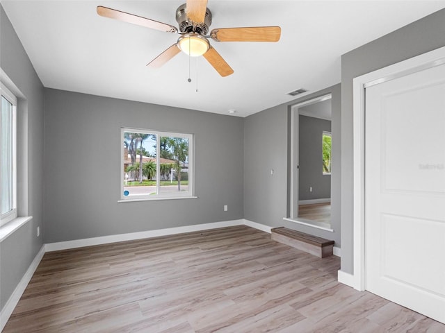 540 80th Ave, St Pete Beach, FL 33706 - unfurnished room with healthy amount of natural light, light wood-style floors, and a ceiling fan